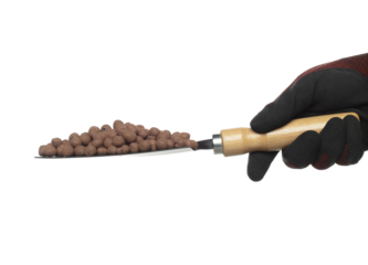 Clay Drainage big size ball pour fall down, explosion in shovel hand. Clay Drainage ball splash in shape form line explosion. White background isolated high speed shutter freeze motion