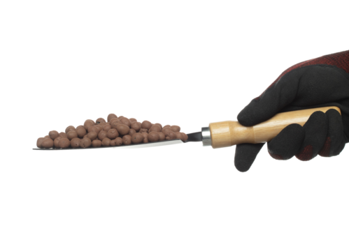 Clay Drainage big size ball pour fall down, explosion in shovel hand. Clay Drainage ball splash in shape form line explosion. White background isolated high speed shutter freeze motion