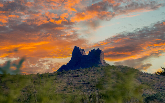 Geologic formation in Arizona desert with colorful sky with clouds