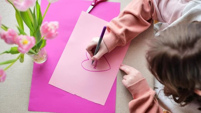 I love you mom.Mothers Day.moms day. DIY postcard.Message to mom. child makes a card for his mother. Flowers and cards for mom.Daughter draws a card for mom. 4k footage