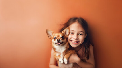 Little girl and her puppy embracing on peach fuzz background.