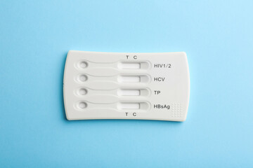 Disposable multi-infection express test on light blue background, top view