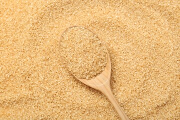 Spoon on granulated brown sugar, top view