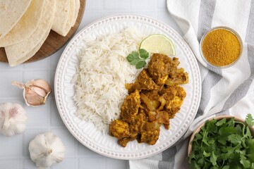 Delicious chicken curry with rice and ingredients on white tiled table, flat lay
