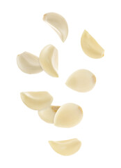 Fresh garlic cloves falling on white background
