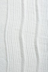 Zen rock garden. Wave pattern on white sand, top view