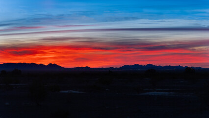 Arizona sky over silhouette of geological formation in the desert 