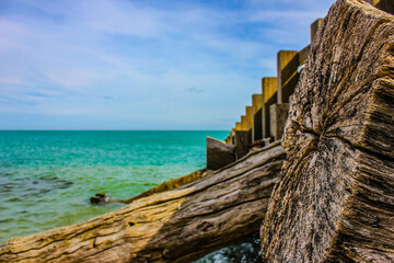 wooden element on the background of the sea, blue water, ocean coast
