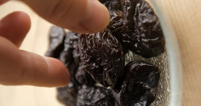Prunes in plate serving, vertical 4K