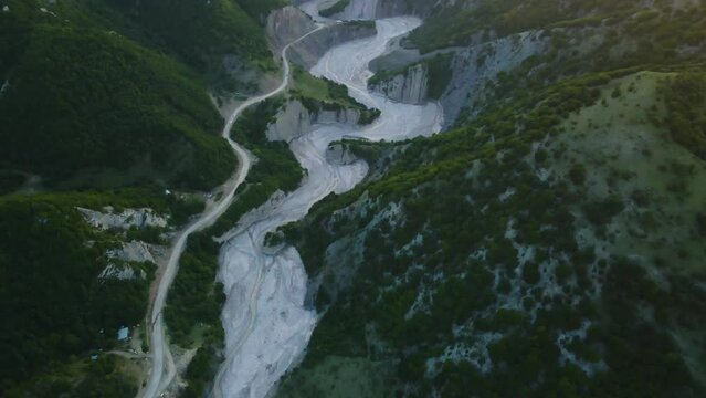 Drone shot flying over the Girdimanchay river near the town of Lahic, Azerbaijan during sunset.