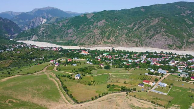 Drone shot flying over the town of Lahic in Azerbaijan while panning up and to the left.