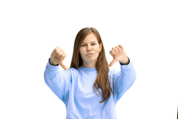 A woman, close-up, on a white background, shows her thumbs down