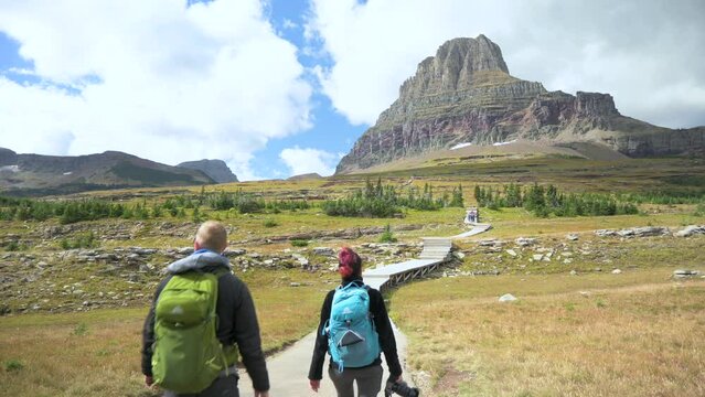 Hikers walking towards Clements Mountain on the Hidden Lake Trail in Glacier National Park, static