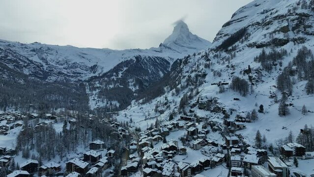 Ski town of Zermatt Switzerland on a cold winter day with the matterhorn and the dramatic Swiss alps mountains in the background. Ski resort in Europe.