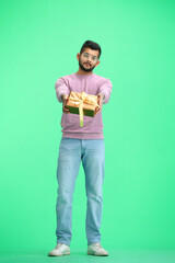 A man, on a green background, in full height, with a gift