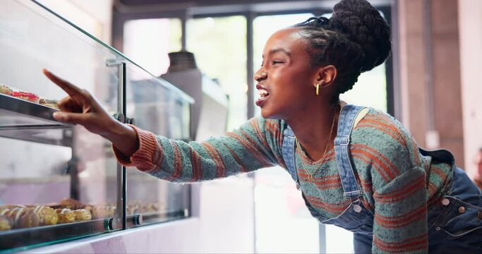 Bakery, counter and black woman with choice of pastry for happy customer in small business with treats. Cafe, sweets and girl at display window with decision for cake, dessert or cookies in glass.