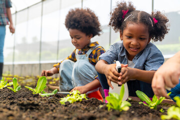 Happy African farmer family on agriculture farm growing organic vegetable together in greenhouse...
