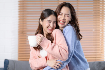 Beautiful two Asian female LGBT lesbian embracing with love and romance , Positive mood and good moment with quality time at warmth place.LGBTQ+ Lifestyle Pride Month