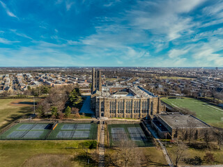 Aerial view of Baltimore City College, liberal arts college preparatory school in Baltimore Homestead Montebello neighborhood built of granite and limestone in a Collegiate Gothic architectural style - obrazy, fototapety, plakaty