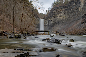 Long exposure winter photo of the Taughannock Falls and bridge at Taughannock Falls State Park near Ithaca NY.  (02-03-2024)