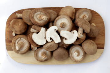 Fresh shiitake mushrooms on white background.