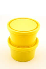 two yellow plastic containers with a lid for storing food
