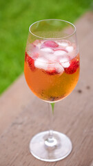 Fresh summer cocktail with strawberry and ice cubes. Glass of strawberry soda drink on dark background. Fresh strawberry cocktail.