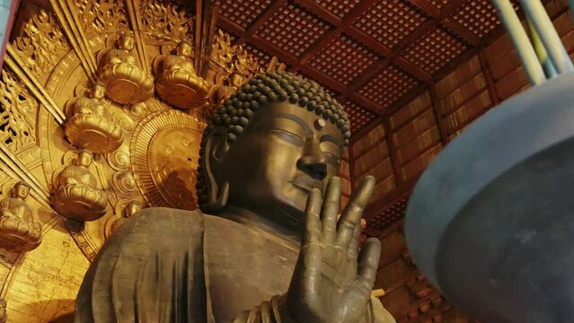 Giant Buddha statue in Tōdai-ji temple with intricate background, Nara, Japan