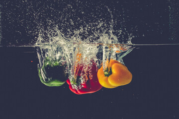The bell pepper fell into the water and splashed
