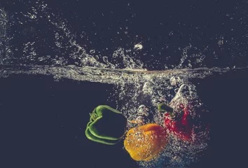 Fotobehang The bell pepper fell into the water and splashed © Nguyen Duc Quang