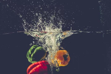 Fotobehang The bell pepper fell into the water and splashed © Nguyen Duc Quang