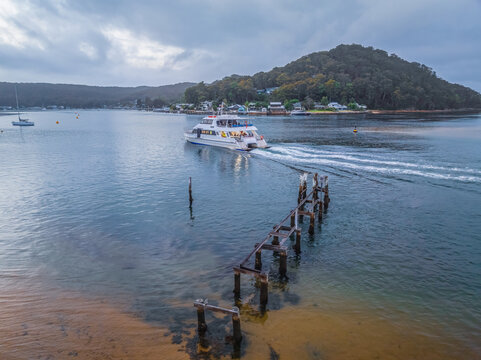 Overcast aerial sunrise and early morning ferry commuters heading over the bay