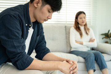 Fototapeta premium Divorce. Asian couples are desperate and disappointed after marriage. Husband and wife are sad, upset and frustrated after quarrels. distrust, love problems, betrayals. family problem, teenage love