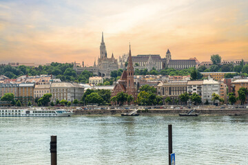 Danube River in Budapest city, Hungary. Urban landscape with old historical buildings. Reddish sky in the background.