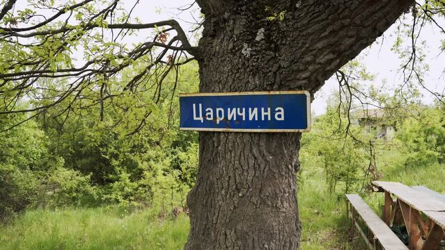 Panning from the left to the right side of the frame showing a sign of Kralicka posted on a tree in what is known as Area 51 or Tsacharina Hole in Bulgaria.