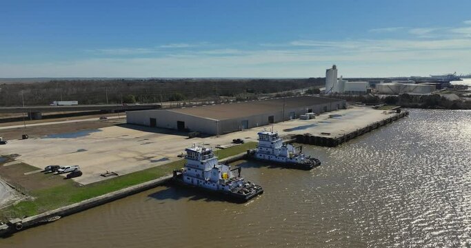 Mobile River industrial park near the Cochrane Causeway and push boat docked near warehouse
