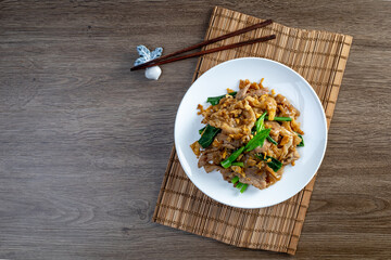stir fried large noodles with soy sauce, dish of PAD SEE EW