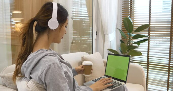Empty Green Screen laptop Blogger Woman hands typing Laptop computer keyboard. Close up women hands using laptop sitting sofa living room. Freelance women work from home office video call conference
