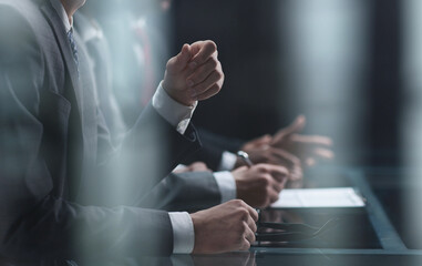 Multicultural professional businesspeople working together on research plan in boardroom.