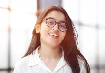 A close up head shot portrait of a preppy, young, beautiful, confident and attractive woman