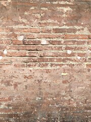 Grunge Red Stonewall Background. Shabby Building Facade With Damaged Plaster.
