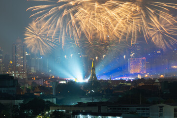 Fireworks of Temple of Dawn or Wat Arun with urban city town in Rattanakosin Island in architecture, Urban old town city, Bangkok skyline. downtown area at night, Thailand.