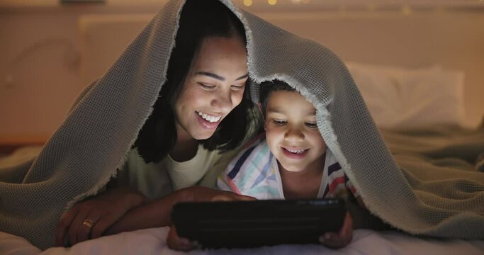Night, bedroom and mother with boy, tablet or typing with storytelling or bonding together. Family, mama or kid with technology or home with toddler or child development with gaming, blanket or smile