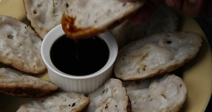 Fluffy ground rice powder pancake Bengali chitoi Dhaka  Chikui  Sora pitha serviced with liquid molasses on rustic wood table background