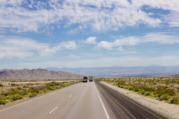 Beautiful blue sky with fluffy clouds over the highway on a spring day. Arizona sign. Scenic road in Arizona, USA on a sunny summer day. Arizona, USA - 17 April 2020