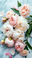 Obraz na płótnie Canvas Stunning peonies spread on a marble surface creating a combination of rugged texture and soft flower elegance