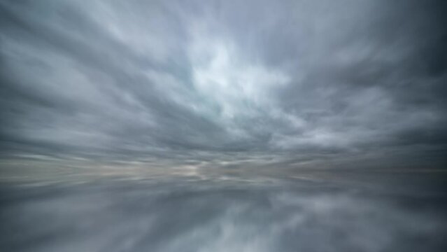 Fast-moving stormy clouds reflected in the water creating an abstract effect.