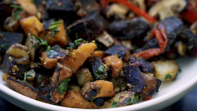 nice shot of Making a shitake mushroom and purple potato breakfast dish for vegan plant based lifestyle assorted peppers sweet potato