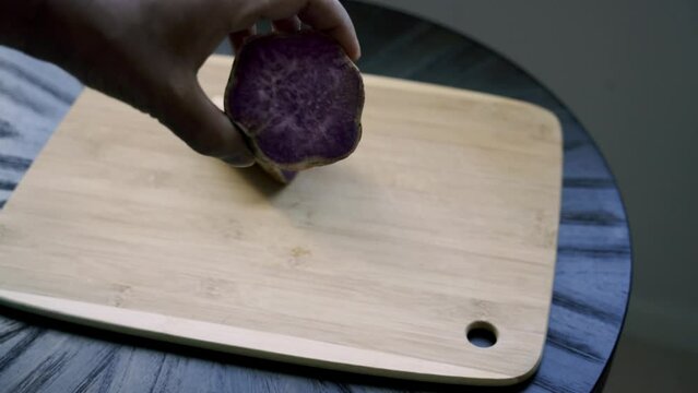 Displaying the inside of a purple potato Making a shitake mushroom and purple potato breakfast dish for vegan plant based lifestyle assorted peppers sweet potato
