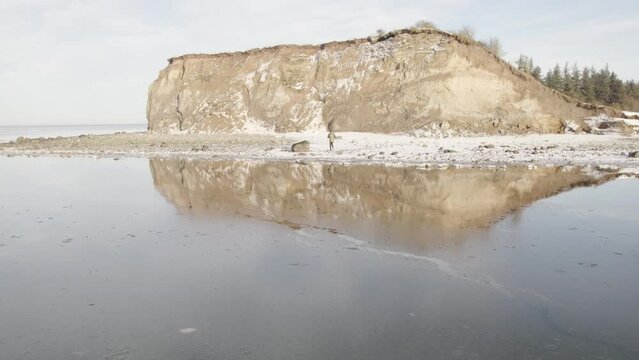 Famous Fur Island Cliff Reflection In the Limfjord Frozen Water at Winter - Aerial Drone Shot